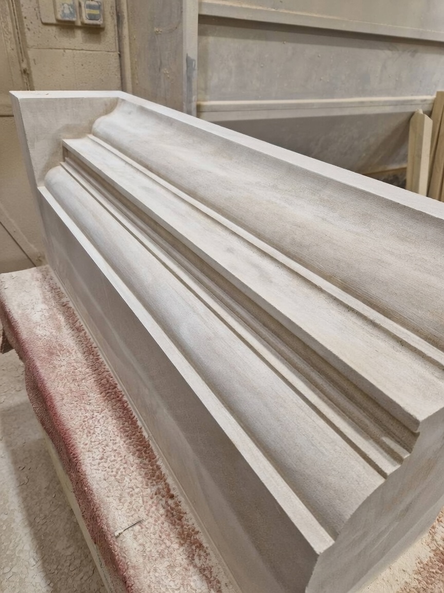 Length of hand-worked limestone cornice with a cyma moulding and stepped fillets, cut to profile on the workshop banker